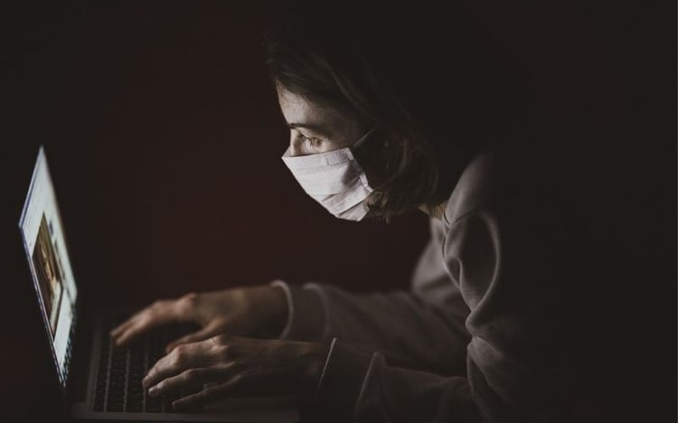 Masked criminal on a laptop