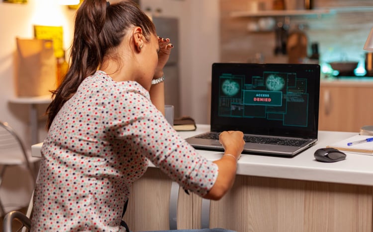 Woman on the laptop with access denied notification