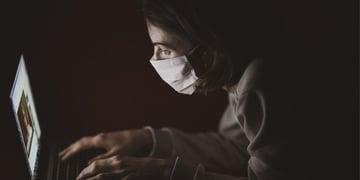 Masked criminal on a laptop